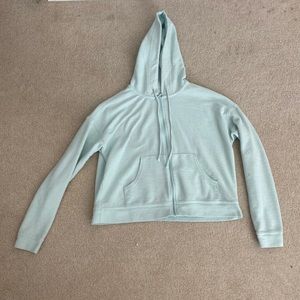 a shorter type zip up. a womens xs and has great condition. mint, teal ish color